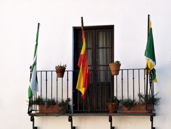 Multi colored flags hanging on wall of building