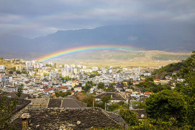 High angle view of rainbow over buildings in city