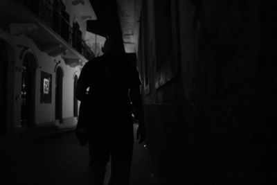 Silhouette people walking in the dark