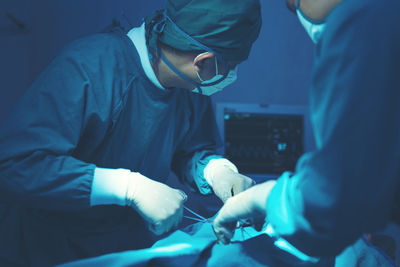 In a operating room, a doctor or medical team is performing a surgical procedure. person