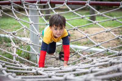 Full length of boy playing at playground