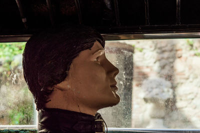 Portrait of man looking through window