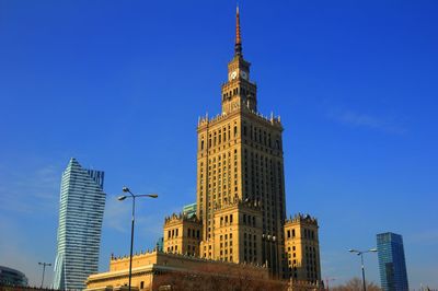 Low angle view of buildings against clear blue sky