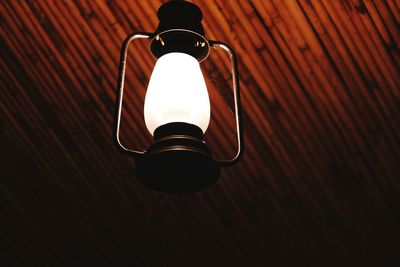 Low angle view of illuminated lantern hanging on ceiling