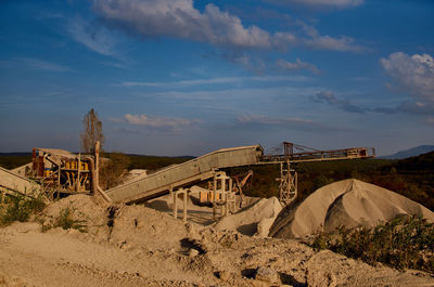 Construction site on shore against sky