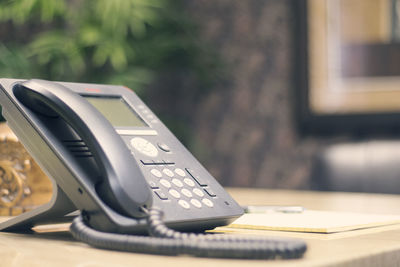 Close-up of telephone on table