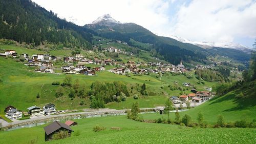 High angle view of houses by mountains in village