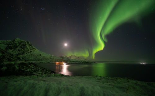 Scenic view of lake against sky at night