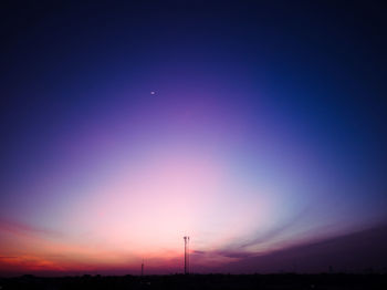 Silhouette landscape against sky at sunset