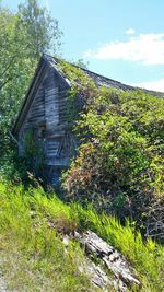 View of abandoned house against cloudy sky