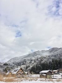 Scenic view of mountains against cloudy sky