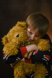 Close-up of boy and  stuffed toy