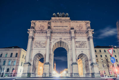 Low angle view of historical building at night