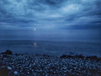 Scenic view of sea against cloudy sky