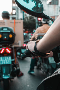 Close-up of person riding scooter on street