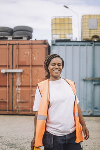 Portrait of happy construction worker standing at site