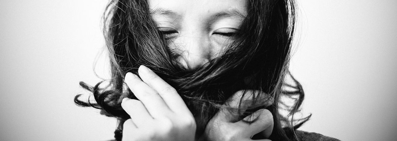 CLOSE-UP OF YOUNG WOMAN WITH HAIR