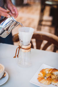 Close-up of barista making coffee in cafe