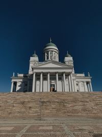 Low angle view of historic building against clear blue sky