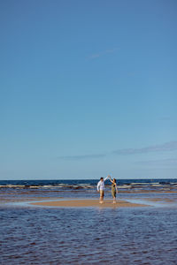 A man and a woman in love embrace and walk in nature. happy walking on the beach and dancing