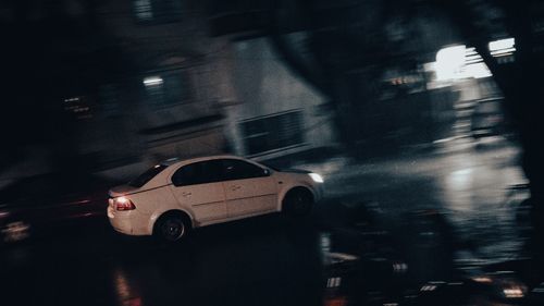 Blurred motion of car on road in rain