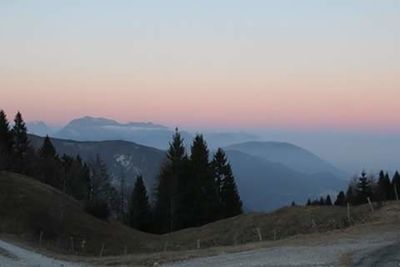 Scenic view of silhouette mountains against sky at sunset