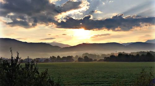 Scenic view of field against sky during sunset