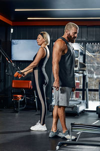 Side view of woman exercising in gym