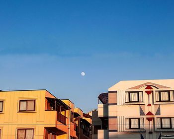 Low angle view of buildings against blue sky