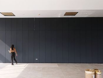 Woman standing in front of wall