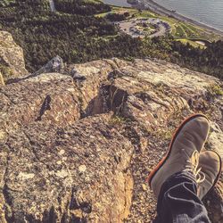 Low section of man standing on rock