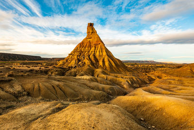 Rock formations on landscape against sky