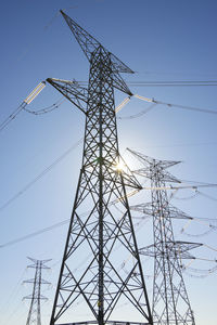 Low angle view of electricity pylon against sky