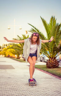 Portrait of a young woman against tree