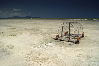 Crab pot on shore at beach