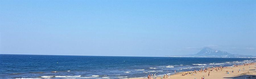 Scenic view of sea against clear blue sky