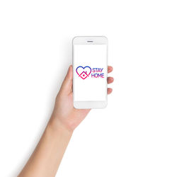 Close-up of hand holding mobile phone over white background