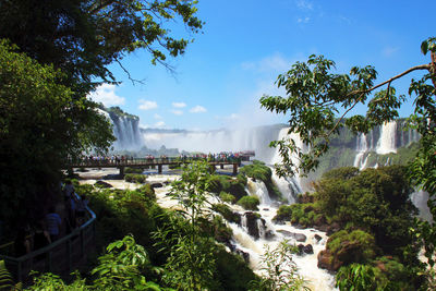 Scenic view of waterfall against sky