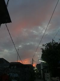 Low angle view of silhouette buildings against sky at sunset