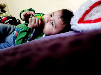 Portrait of cute boy looking away at home