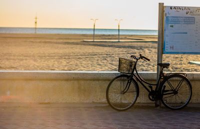 Bicycle on beach against sky