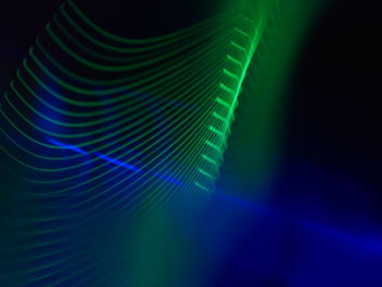 Abstract image of illuminated lights over black background