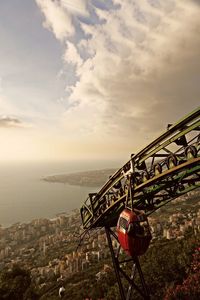 High angle view of teenage boy sitting on overhead cable car