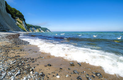 Scenic view of beach against clear sky
