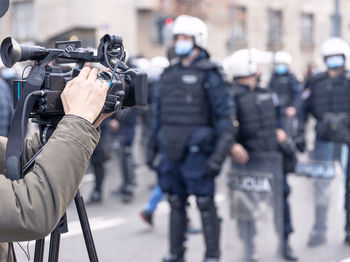 Filming riot police during crowd demonstration against covid-19 pandemic restrictions