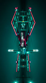 Low angle view of illuminated lights against black background