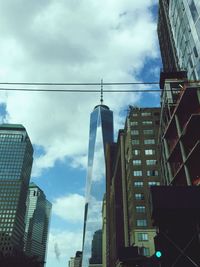 Low angle view of buildings against cloudy sky