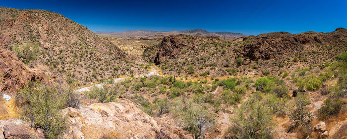 Scenic view of mountains against clear blue sky