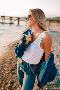 Young woman looking down while standing on land