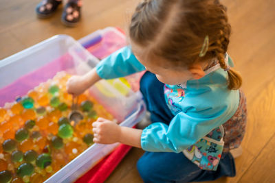 High angle view of boy playing on table